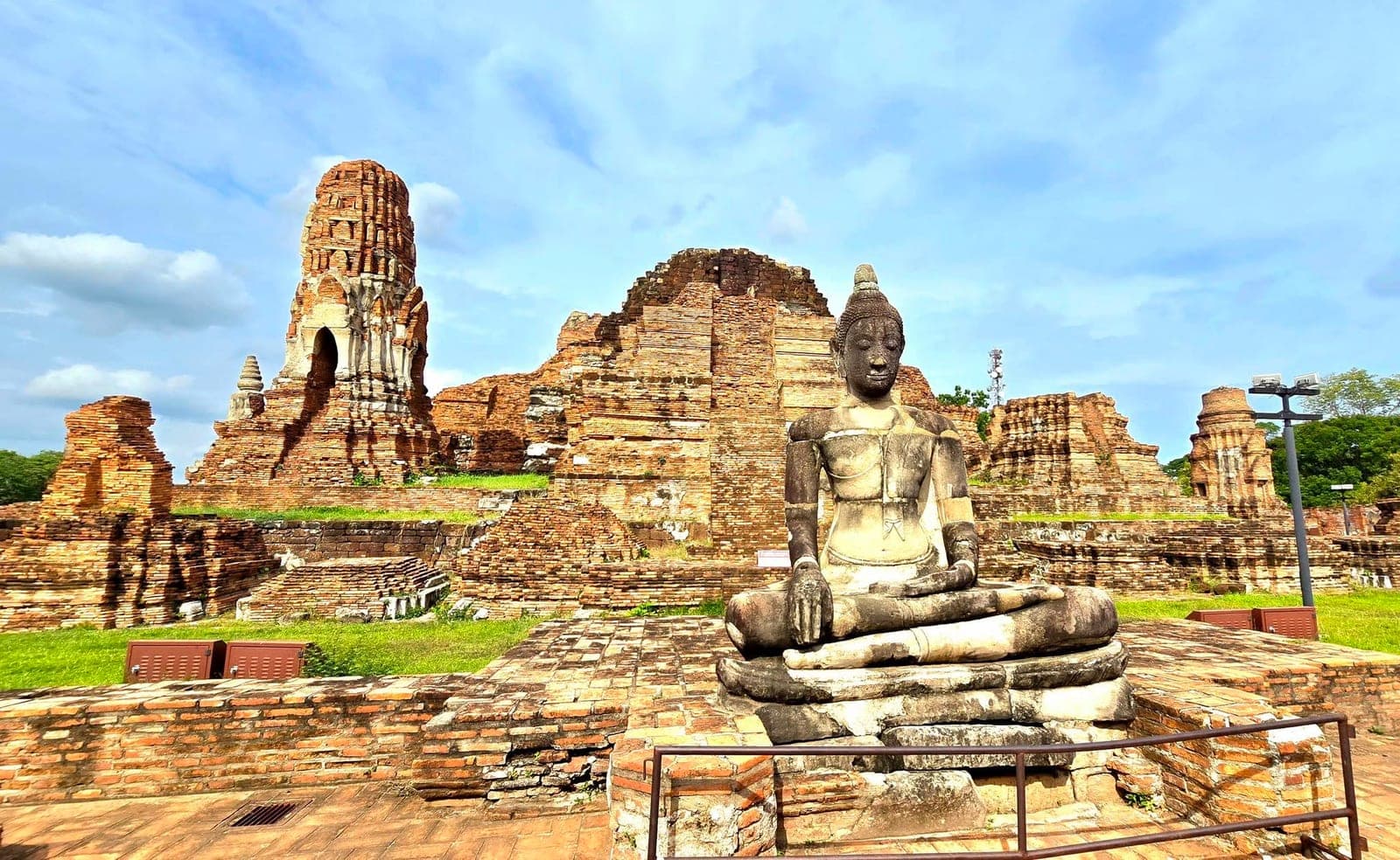 Seated Buddha among the brick prangs of Wat Mahathat, Ayutthaya