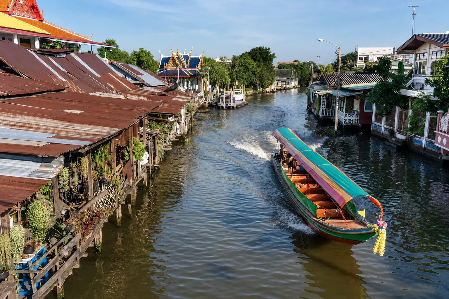 Longtail boat gliding through the Thonburi canals in Bangkok