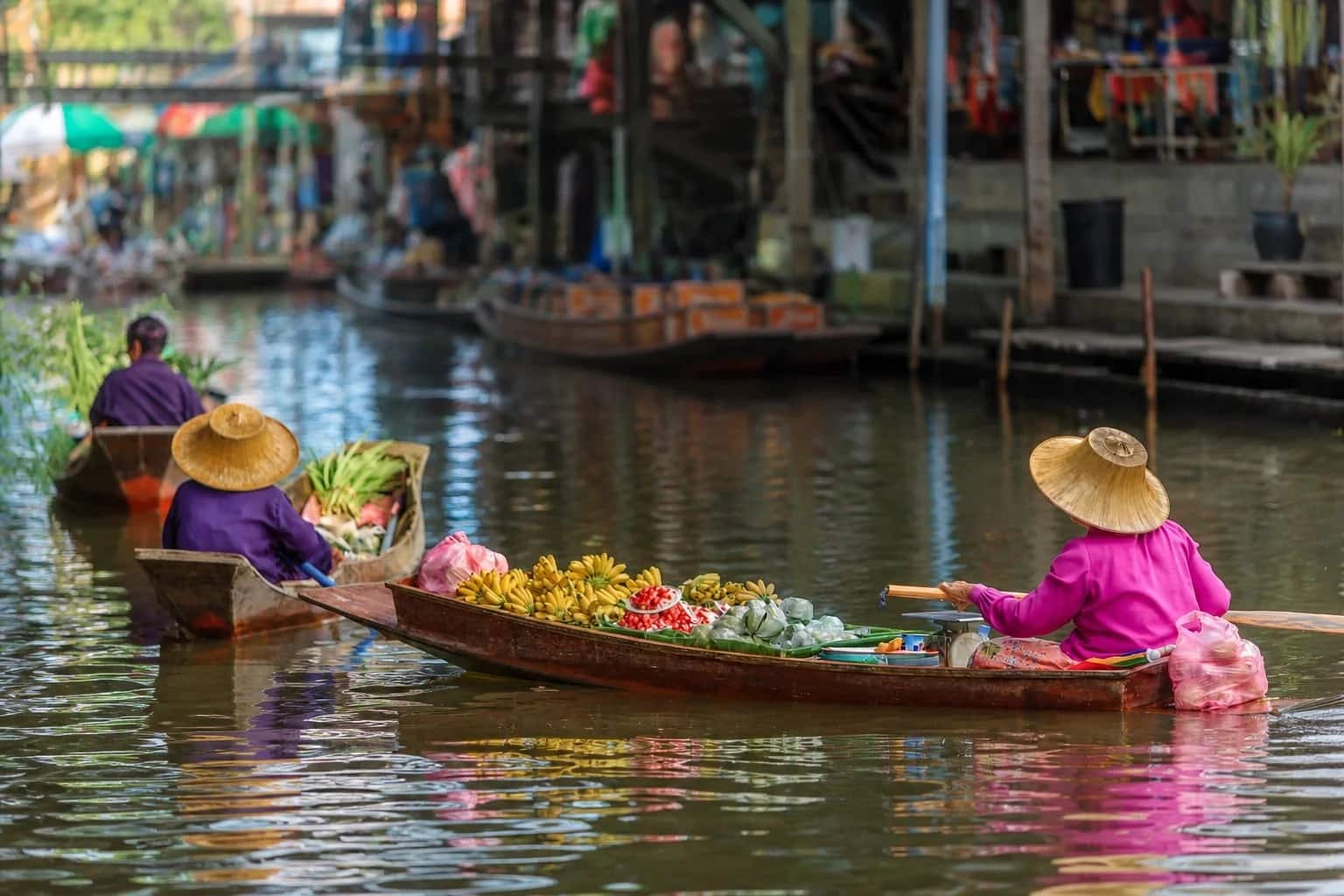 Fruit vendor boats on the canal at Amphawa Floating Market near Bangkok